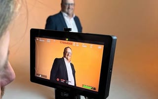 Readymode CRO, Rob Auld, smiling behind a video camera.