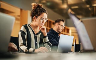 Woman working on a laptop.