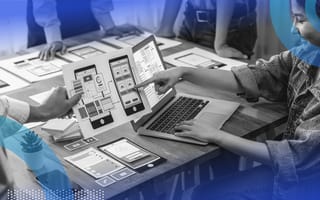 developers working on app development reviewing blueprints