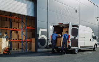 Worked load packages for delivery at e-commerce warehouse.