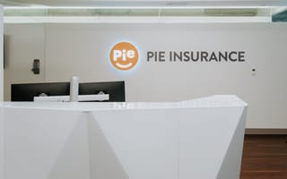 A lit Pie Insurance logo shines in the company’s lobby.