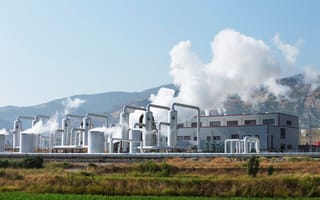 Geothermal energy plant surrounded by mountains.