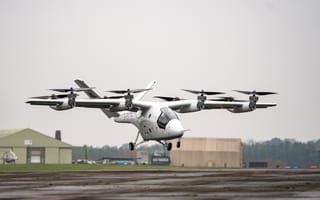 Electric aircraft pictured hovering over the ground.