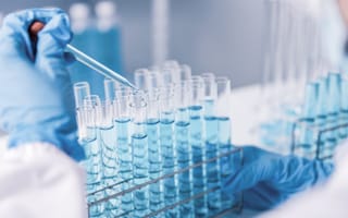 researcher's gloved hand performing experiment