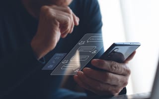A man uses a smartphone and a rendering of a conversation with a chatbot hovers above the screen.