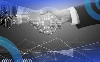A human hand and a digital hand shaking hands.