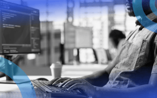JavaScript developer reviewing code on computer