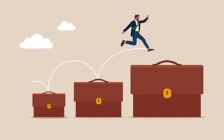 An employee jumps from a small brief case to a large briefcase, representing their advancement from an individual contributor to a manager.