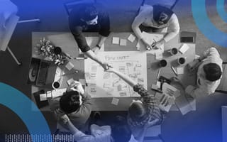 People seated at a table are organizing a Scrum project.