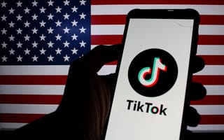 TikTok on a phone screen in front of an American flag.