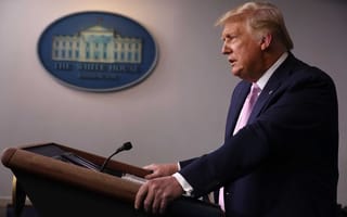President Donald Trump speaks at a lectern.