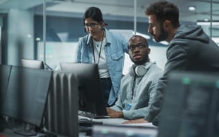IT emplpyees analyze code.