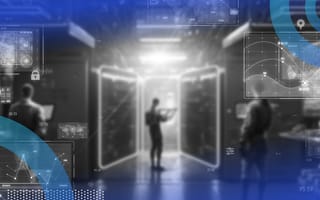 A researcher stands and examines servers
