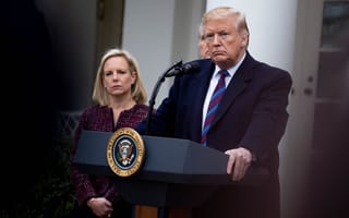 President Donald Trump stands behind a lectern.