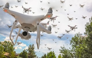 A group of drones flying through the sky.