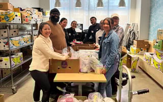 Allywn North America employees posing for a photo while volunteering at a food drive together