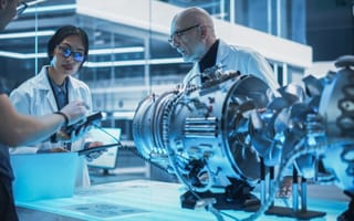 Aerospace engineers assemble jet engine.