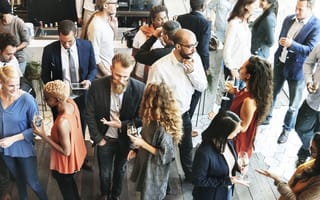A group of intermingling people is shown.