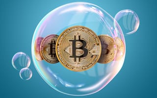 A bubble surrounds gold coins engraved with the Bitcoin logo.