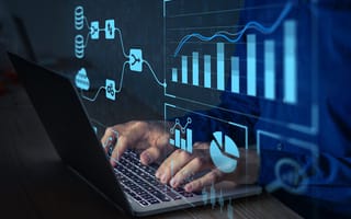 An illustration featuring various graphs to depicting data analytics overlays a close up of a pair of hands typing on a laptop keyboard.