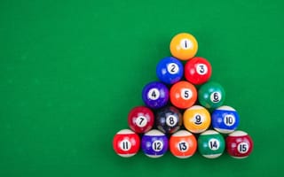 Pool balls arranged in a triangle are shown.