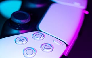 A close up photo of a PlayStation controller is shown.
