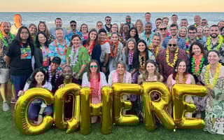 Cohere Health team members gather for a group photo by the ocean during an offsite
