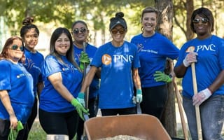 PNC team members pose for a group photo while volunteering together