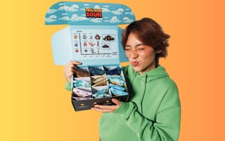 A person holding a box of Final Boss Sour snacks is shown.