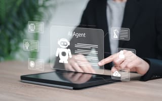 A hand reaches toward a tablet screen with an overlaid illustration featuring a robot and the words AI Agent.