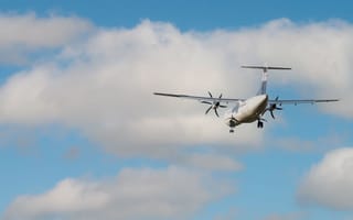 A plane is shown flying through clouds