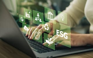 A pair of hands type on a laptop keyboard overlaid by green boxes featuring icons for ESG, recycling and other sustainability initiatives.