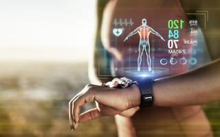 A person wearing a smartwatch with a digital health display showing heart rate and vitals.
