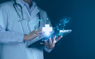 Doctor in white coat uses a tablet with holographic medical icons.