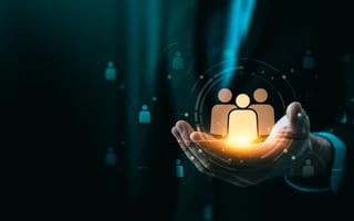 A person's cupped hands holding a glowing digital icon of three people, symbolizing teamwork or customer care.