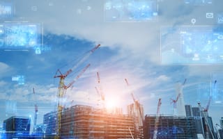 Construction site with cranes under a blue sky, overlaid with digital technology icons and data graphics.