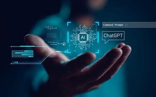 AI and ChatGPT holograms float above someone's open palm.