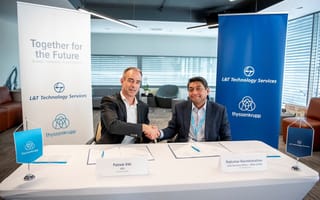 Two executives are shown at a signing event.
