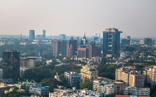 A photo of Bengaluru's skyline is shown.
