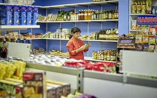 A person is pictured shopping in a small grocery store.