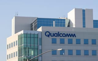 Tall modern building with glass windows and the Qualcomm logo.