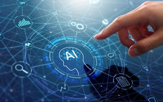 A hand reaches toward a digital interface featuring a head silhouette with "AI" inside.