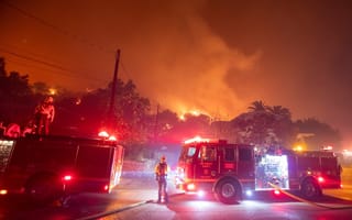 Firefighters arriving at the scene of a wildfire are pictured.