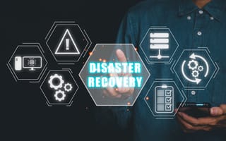 A hand reaches toward a digital illustration that says Disaster Recovery surrounded by icons like gears and exclamation marks.