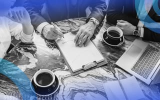 A group of executives work around a table