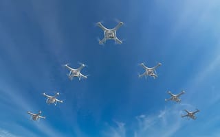 A group of drones flying in the sky