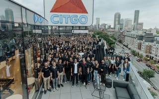 WHOOP team members pose for a large group photo on a rooftop in Boston