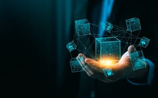 An illustration of several connected blocks hovers over a hand to represent blockchain.