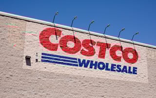 A closeup of the red and blue Costco Wholesale logo on the side of a retail store.