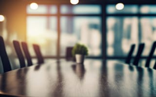 A blurry photo of a boardroom is pictured.